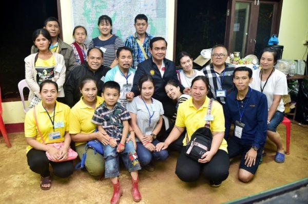 Thailand's Prime Minister Prayuth Chan-ocha poses with relatives of boys trapped in a flooded cave at the Tham Luang cave complex in Chiang Rai, Thailand, July 9, 2018. Picture taken July 9, 2018. (Thailand Government House/Handout via Reuters)
