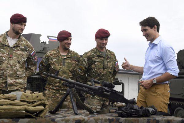 Prime Minister Justin Trudeau speaks to Slovenian soldiers during a visit to Adazi Military Base in Kadaga, Latvia, on July 10, 2018. (AP Photo/Roman Koksarov)