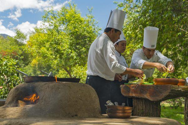 Diners watch Tambo del Inka hotel staff cook in a traditional Andean oven. (Courtesy of Tambo del Inka, a Luxury Collection Resort & Spa)