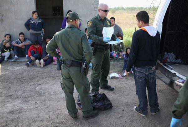 Border Patrol agents check illegal immigrants' documents in Texas by the U.S.–Mexico border on Dec. 8, 2015. (John Moore/Getty Images)