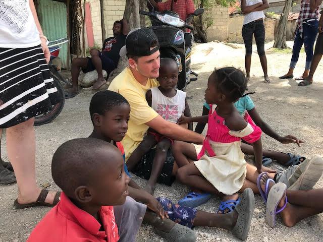 Team members with children in Haiti. (Courtesy of Emily Wheaton)