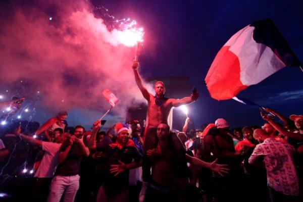 Fans in France celebrate in front of the Arc de Triomphe on the Champs-Elysée after France won the Soccer World Cup final. (Gonzalo Fuentes/Reuters)