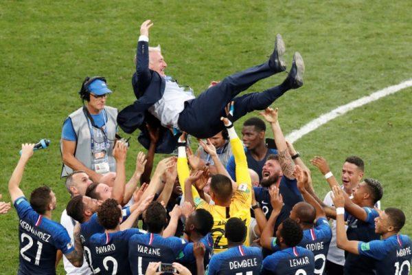 France's coach Didier Deschamps is held up by players to celebrate winning the World Cup. (Christian Hartmann/Reuters/File Photo)