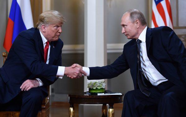 President Donald Trump and Russian President Vladimir Putin shake hands before a meeting in Helsinki, on July 16, 2018. (Brendan Smialowski/AFP/Getty Images)