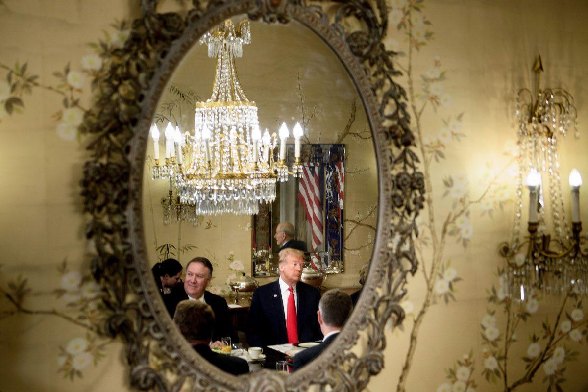 President Donald Trump (R) and Secretary of State Mike Pompeo (L) are reflected in a mirror as they attend a breakfast meeting with the NATO Secretary General and staff at the US chief of mission's residence in Brussels on July 11, 2018. (BRENDAN SMIALOWSKI/AFP/Getty Images)