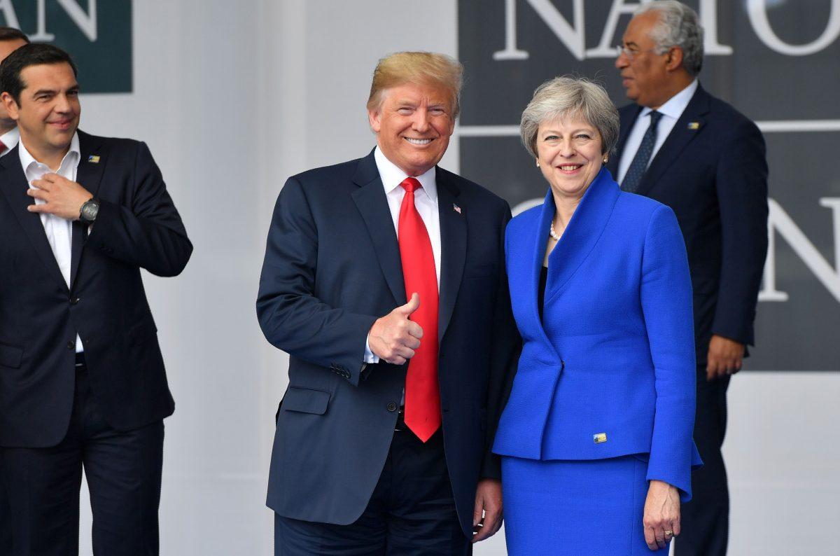 President Donald Trump speaks with UK Prime Minister Theresa May during the opening ceremony of the NATO summit, at the NATO headquarters in Brussels, on July 11, 2018. (EMMANUEL DUNAND/AFP/Getty Images)