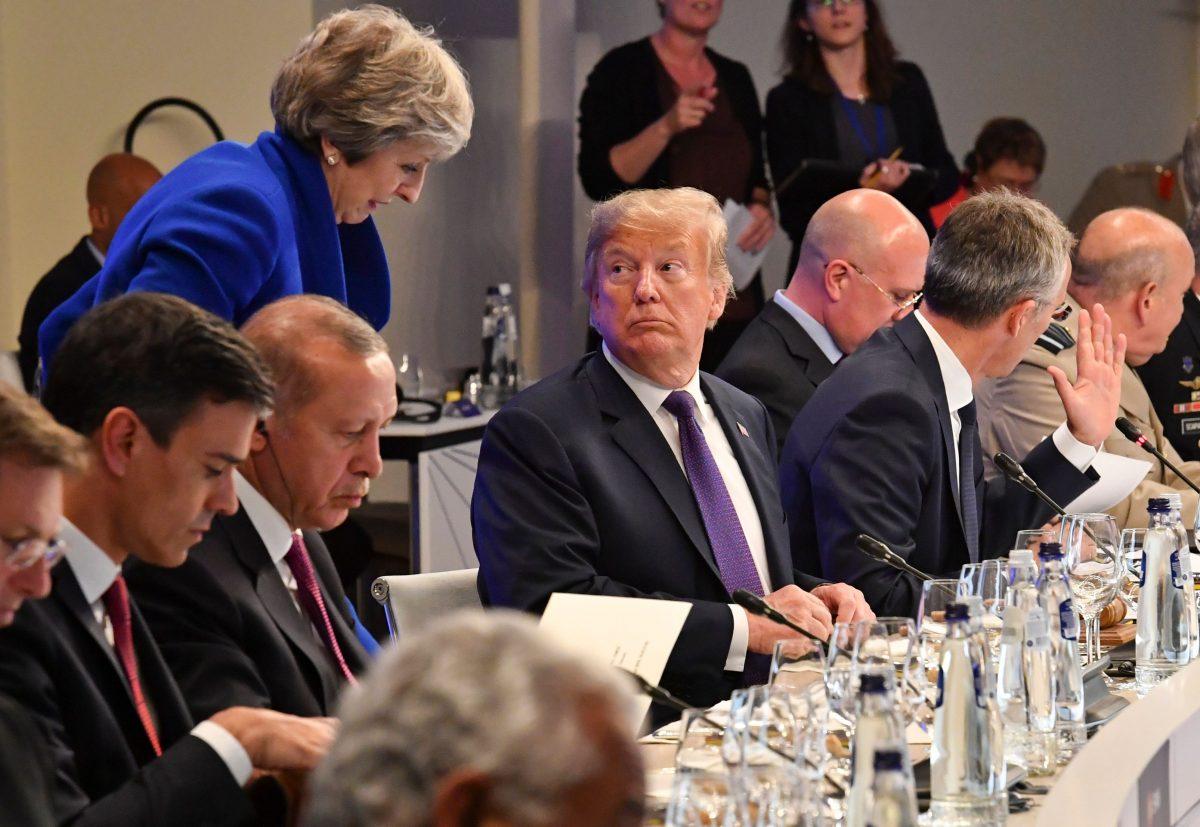 President Donald Trump looks at British Prime Minister Theresa May during a dinner of leaders at the Art and History Museum at the Park Cinquantenaire in Brussels on July 11, 2018. (GEERT VANDEN WIJNGAERT/AFP/Getty Images)