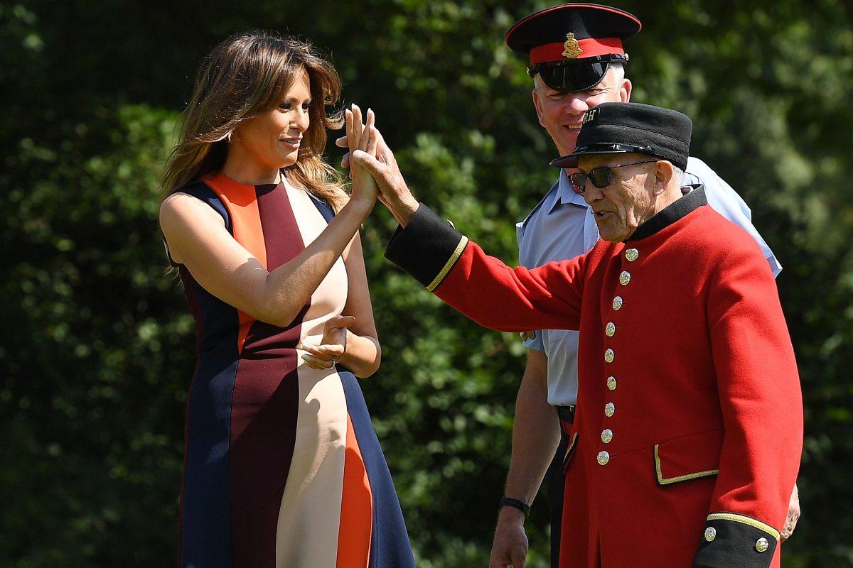 First Lady Melania Trump high-fives a veteran as she tries her hand at bowls during a visit with British Army veterans at Royal Hospital Chelsea in London on July 13, 2018. (Leon Neal/Getty Images)