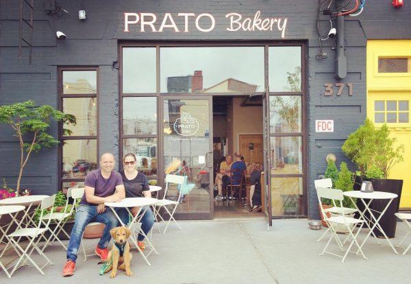 Simone Bertini, Teresa Villi, and their dog in front of Prato Bakery, in Jersey City, N.J. (Karen Fuchs)