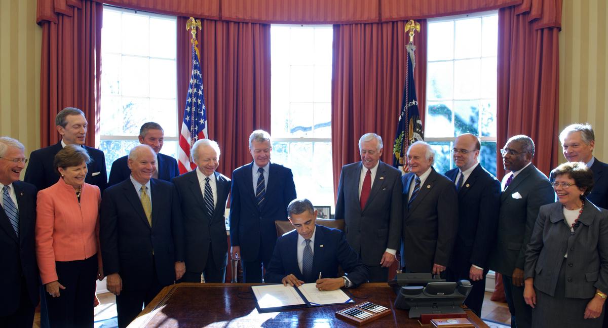 President Barack Obama signs H.R. 6156, the Russia and Moldova Jackson-Vanik Repeal and Sergei Magnitsky Rule of Law Accountability Act, on Dec. 14, 2012, in the Oval Office of the White House in Washington, DC. (MANDEL NGAN/AFP/Getty Images)