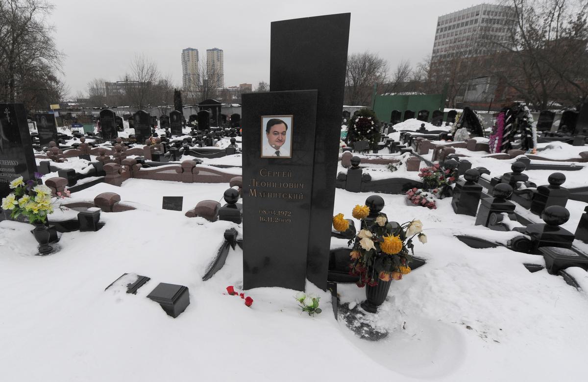 The snow-clad grave of Russian lawyer Sergei Magnitsky with his portrait on the tomb (C) at the Preobrazhenskoye cemetery in Moscow on Dec. 7, 2012. (ANDREY SMIRNOV/AFP/Getty Images)
