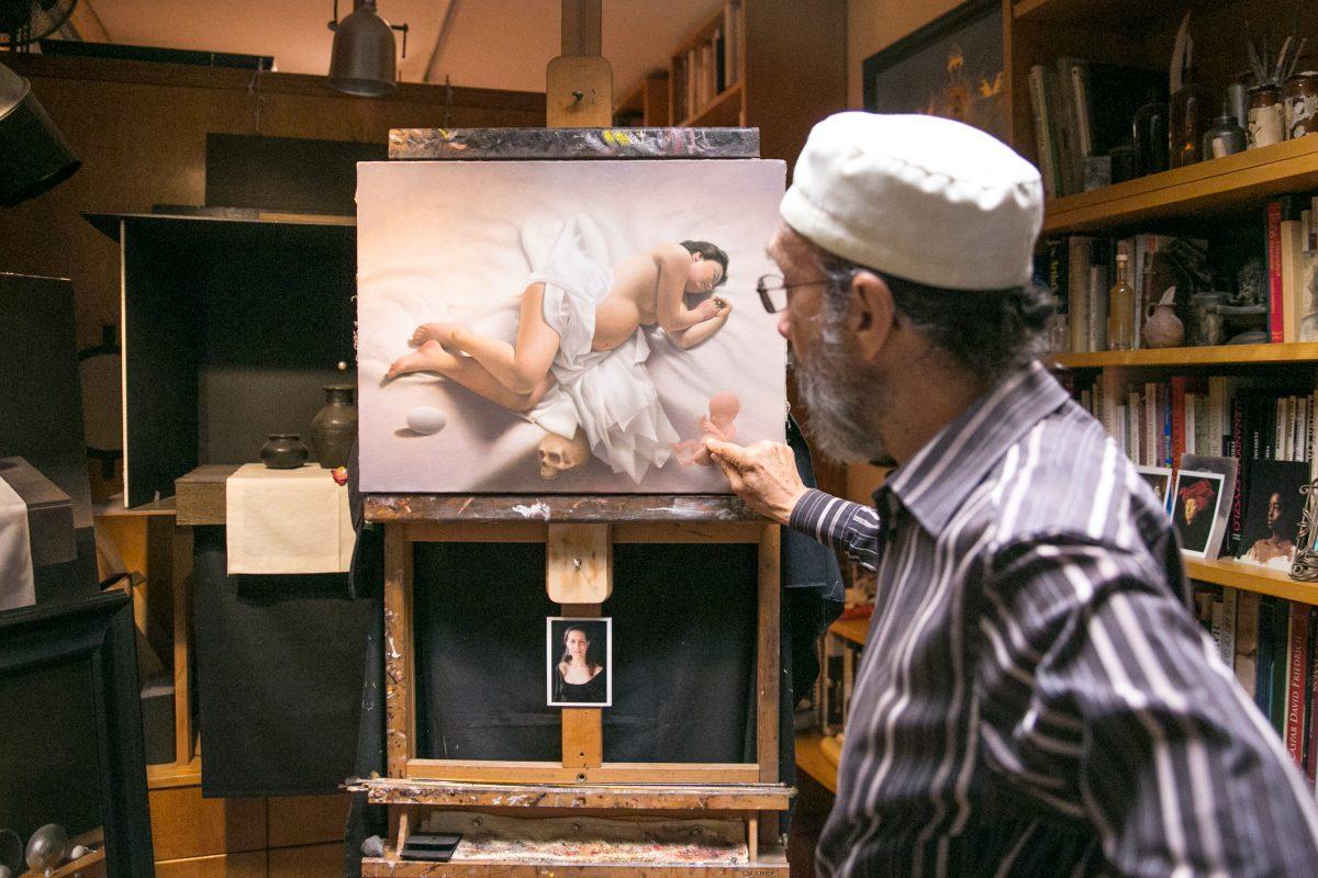 Carlos Madrid talks about his latest painting, "Cyclum Vitae (life cycle)," in his studio on July 3, 2018. (Milene Fernandez/The Epoch Times)