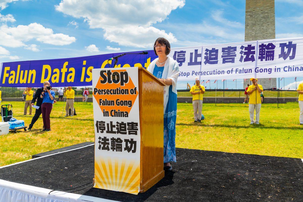 Dr. Zhang Yuhua, a university professor at Nanjing Normal University in China, appeals for an end to the detention of her husband in China, before the Washington Monument on July 19, 2018. (Mark Zou/Epoch Times)