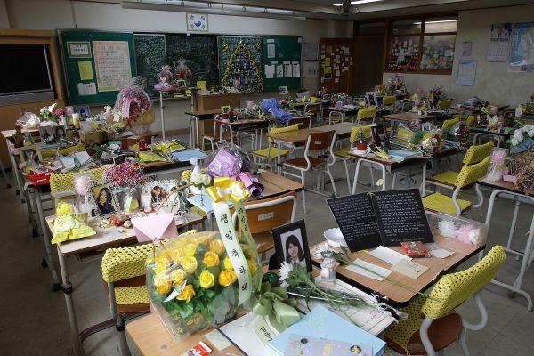 FILE: Flowers and notes from colleagues paying tribute to the victims of the Sewol ferry are on the desks in a second year classroom at Danwon High School on April 16, 2016 in Ansan, South Korea. In 2014, the Sewol ferry carrying 476 passengers capsized near Jindo Island on April 16th in South Korea. Only 172 of the ferry's 476 passengers and crew were rescued, and out of the 304 dead or missing, 250 were school children. (Photo by Chung Sung-Jun/Getty Images)