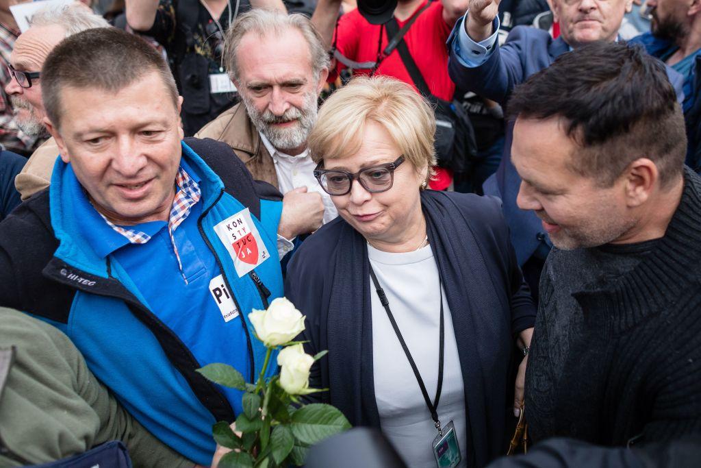 Polish Supreme Court President Judge Malgorzata Gersdorf (Second from L) arrives for work at the Supreme Court building as people gather to support her, on July 4, 2018, in Warsaw. Gersdorf refused to step down, defying a controversial new law by the government that requires her and other senior judges to retire early. (Wojtek Radwanski/AFP/Getty Images)