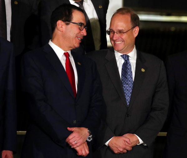 U.S. Secretary of the Treasury Steven Mnuchin talks to Financial Action Task Force President Marshall Billingslea as they pose for the official photo at the G20 Meeting of Finance Ministers in Buenos Aires, Argentina, on July 21, 2018. (REUTERS/Marcos Brindicci)
