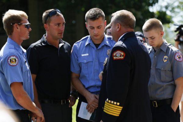 First responders with the Western Taney County Fire Protection District talk with Branson Fire Chief Ted Martin after a memorial service on July 22, 2018 at College of the Ozarks in Point Lookout, Missouri for the families, friends and victims of the duck boat tragedy on Table Rock Lake.(Reuters)