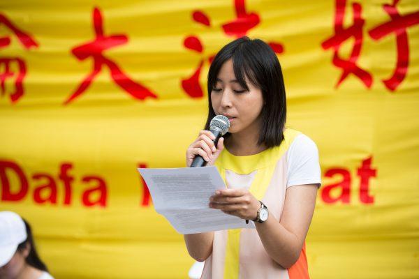 Minghui Yu speaks outside London's Chinese Embassy on July 21. Her family members have suffered severe persecution because of their faith. (Max Lin/Epoch Times)