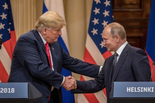 U.S. President Donald Trump (L) and Russian President Vladimir Putin shake hands during a joint press conference after their summit in Helsinki, Finland, on July 16, 2018. (Chris McGrath/Getty Images)
