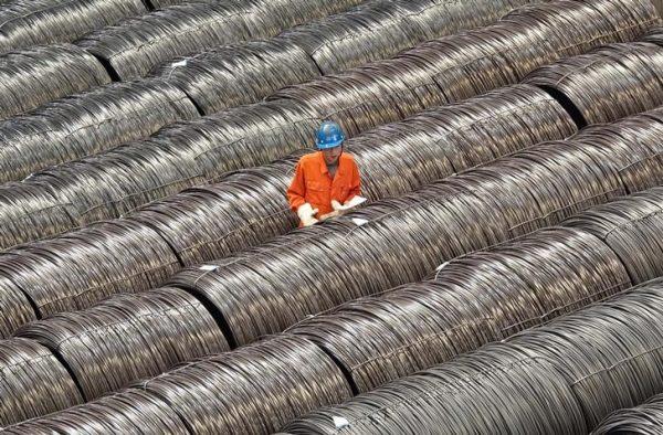 A worker checks steel wires at a warehouse in Dalian City, Liaoning Province of northern China, on May 15, 2017. (Stringer/Reuters)