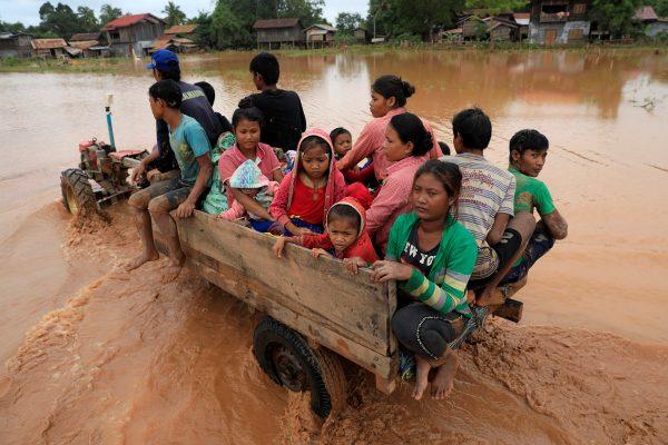 People are seen on a vehicle as they travel during the flood after the Xepian-Xe Nam Noy hydropower dam collapsed in Attapeu province, Laos July 26, 2018. (Reuters/Soe Zeya Tun)