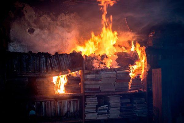 A photo shows books burning inside a house following a wildfire in the village of Neos Voutzas, near Athens, on July 25, 2018. (Angelos Tzortzinis/AFP/Getty Images)