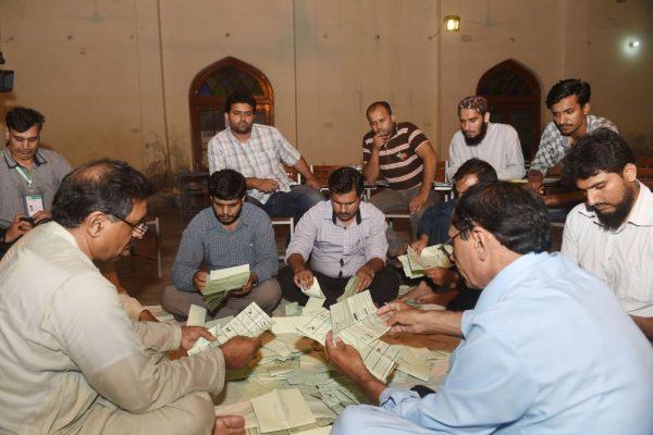 Pakistani election officials count ballots papers after polls closed at a polling station in Lahore on July 25, 2018. (Arif Ali/AFP/Getty Images)