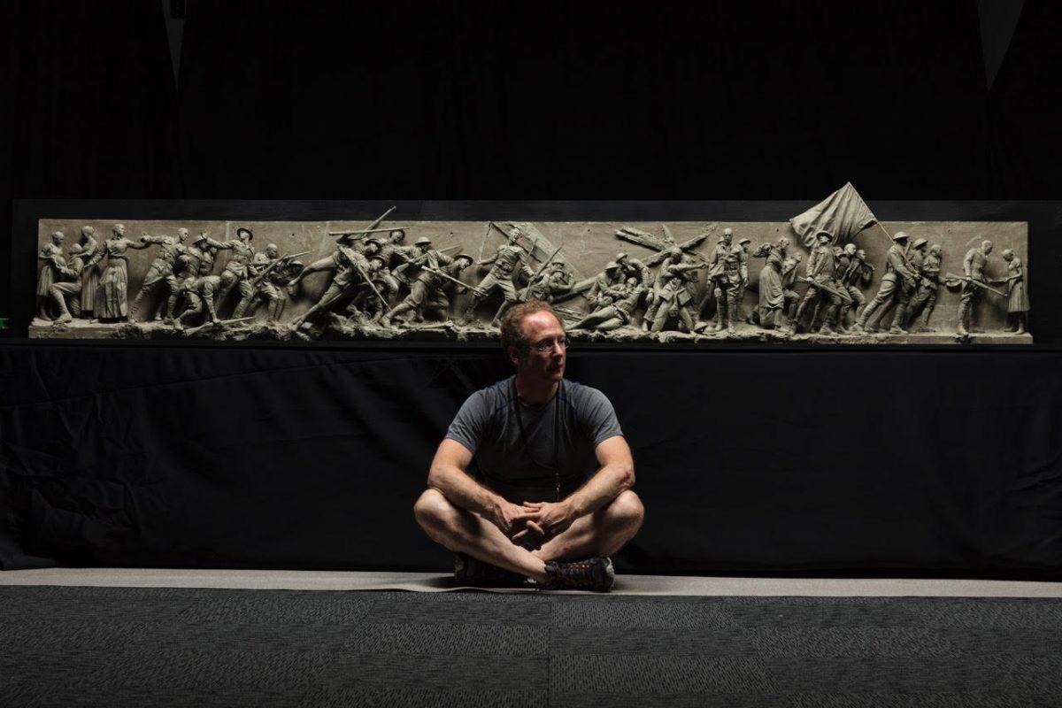 Sculptor Sabin Howard sits with the maquette he created for "A Soldier's Journey," the sculptural component of the National World War I Memorial, in November 2017. (Courtesy of Sabin Howard)