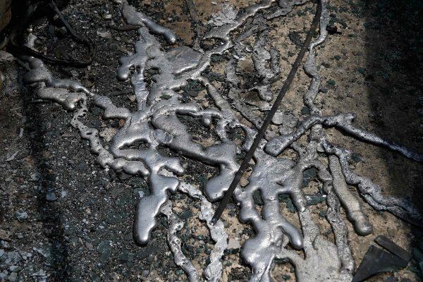 Melted aluminium from cars is seen on the ground following a wildfire at the village of Mati, near Athens. (Reuters/Costas Baltas)