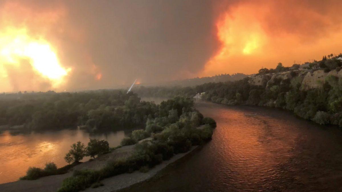 Smoke and flames are seen as a wildfire spreads through Redding, California, the U.S., July 26, 2018, in this still image taken from a video obtained from social media. (Cody Markhart/via Reuters)