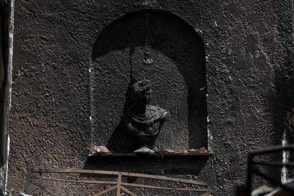 A burnt bust is seen inside a destroyed house following a wildfire in the village of Mati, near Athens, Greece, July 27, 2018. (Reuters/Costas Baltas)