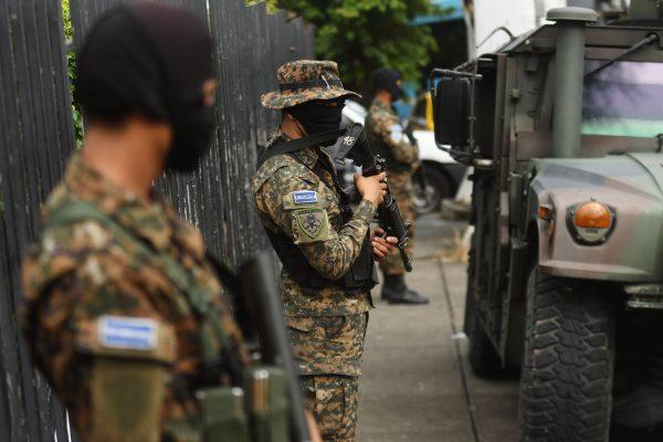 Salvadoran soldiers patrol a bus stop in San Salvador on Oct. 2, 2017, during a government security operation against crime after more than 400 homicides were recorded last September. (MARVIN RECINOS/AFP/Getty Images)