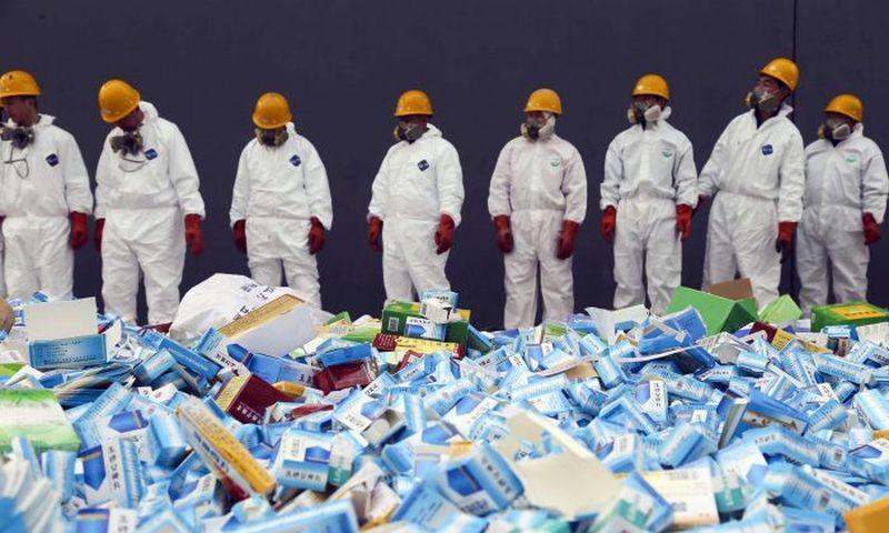 Chinese workers preparing to destroy fake medicines seized in Beijing, on March 14, 2013. The U.S. Food and Drug Administration announced on July 13, 2018 the recall of the heart medicine valsartan, made by Chinese firm Zhejiang Huahai, which was found to be contaminated by a carcinogen. (STR/AFP/Getty Images)