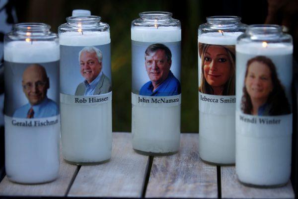 Candles representing the slain Capital Gazette journalists sit on display during a candlelight vigil held near the newspaper's office, the day after a gunman killed five people inside the building in Annapolis, Maryland. (Reuters/Leah Millis)