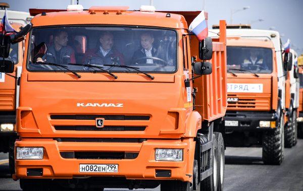 Russian President Vladimir Putin drives a construction truck across the newly inaugurated Kerch Strait Bridge linking mainland Russia to Moscow-annexed Crimea during the opening ceremony on May 15, 2018. (Alexander Nemenov/AFP/Getty Images)
