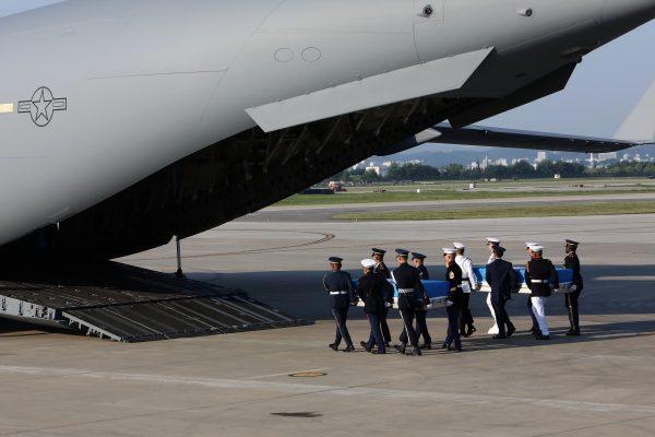 U.N. honor guards carry caskets containing remains transferred by North Korea, at Osan Air Base in Pyeongtaek, South Korea Aug. 1, 2018. (Chung Sung-Jun/Pool via Reuters)