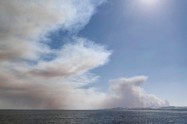 Smoke rises above Clear Lake as the River Fire (Mendocino Complex) burns near Lakeport, California, U.S. Aug. 1, 2018. (Reuters/Fred Greaves)