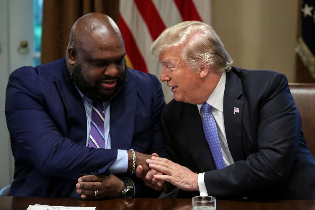 President Donald Trump shakes hands with Senior pastor John Gray during a meeting with inner-city pastors in the Cabinet Room of the White House in Washington on Aug. 1, 2018. (Oliver Contreras - Pool/Getty Images)