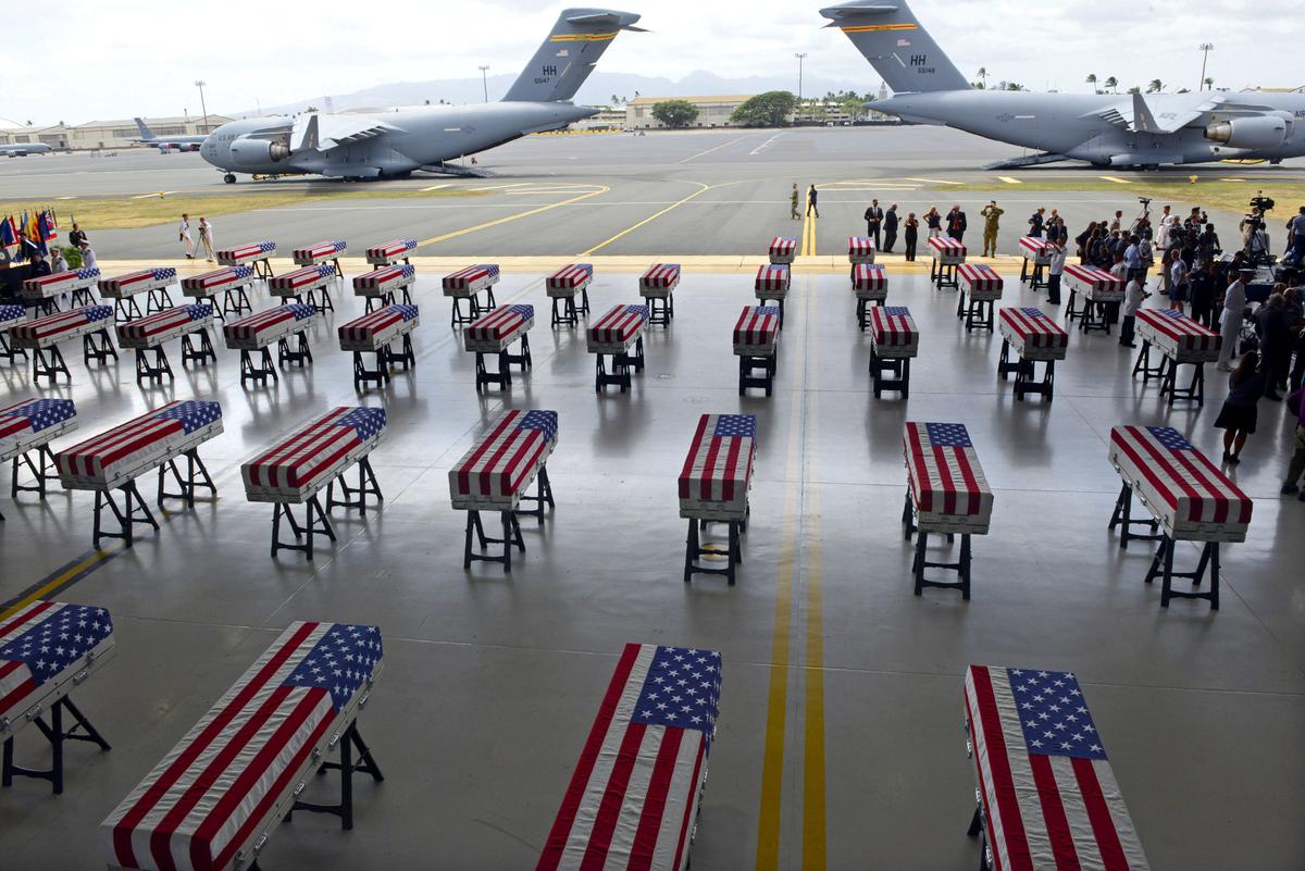 Flag draped transfer cases with the remains of American soldiers repatriated from North Korea are seen during a repatriation ceremony after arriving at Joint Base Pearl Harbor-Hickam, Honolulu, Hawaii, on Aug. 1, 2018. (RONEN ZILBERMAN/AFP/Getty Images)