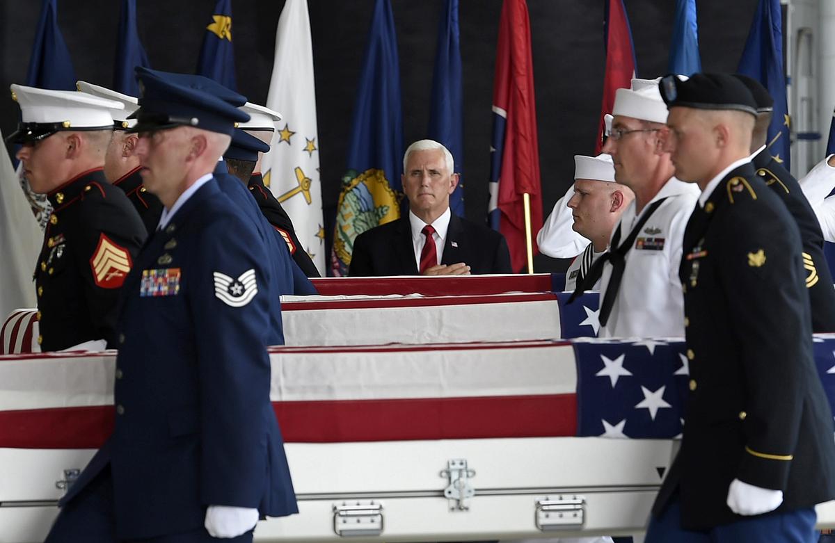 United States Vice President Mike Pence (L) pays respects, as a military honor guard carries the remains of american soldiers repatriated from North Korea during a repatriation ceremony at the Joint Base Pearl Harbor-Hickam, Honolulu, Hawaii, on August 1, 2018. - (RONEN ZILBERMAN/AFP/Getty Images)