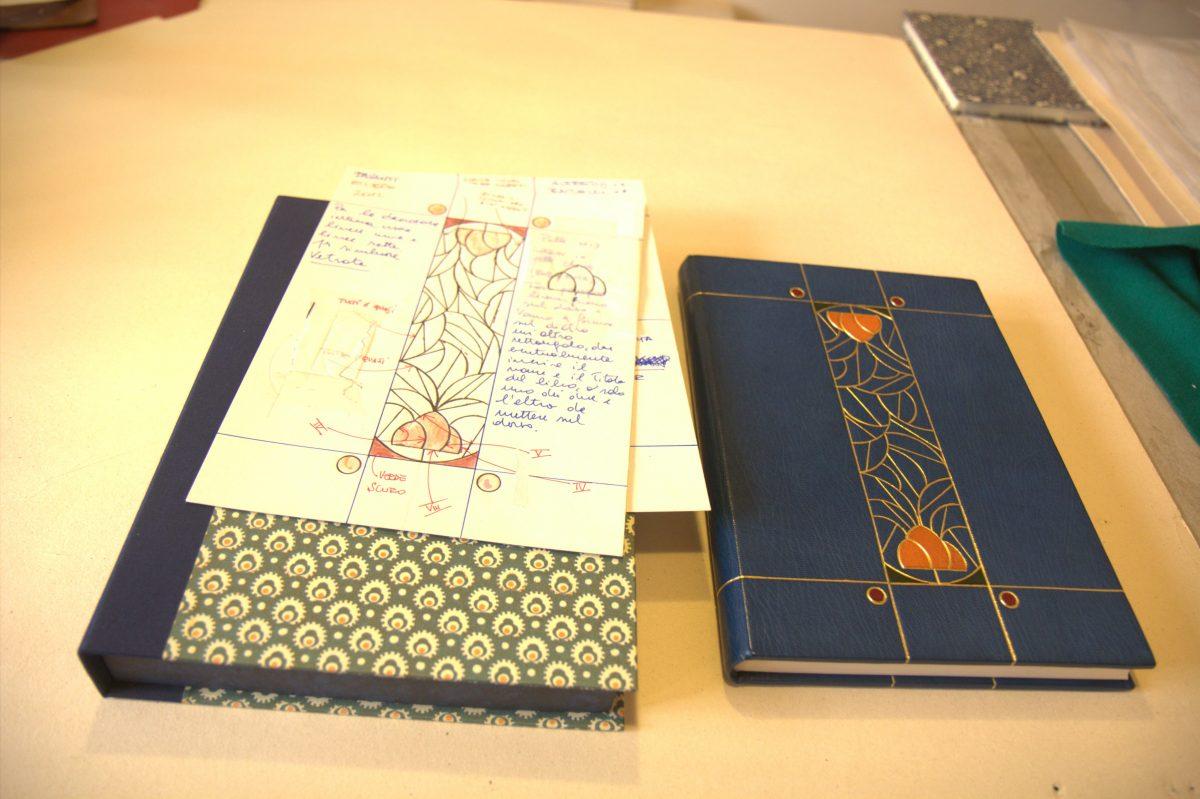 <span style="color: #000000">Preparatory sketches of a liberty-inspired art noveau book cover sit next to the finished book. (Lorraine Ferrier/The Epoch Times)</span>