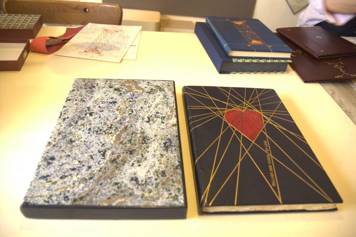 <span style="color: #000000">On the right: Giannini’s artistic bookbinding made in English goatskin and finished with gold leaf, taking a total of one month to make. The book can be bought for 3,000 euros (approximately $3,494). On the left: Book sleeve covered in marble paper and leather. (Lorraine Ferrier/The Epoch Times)</span>