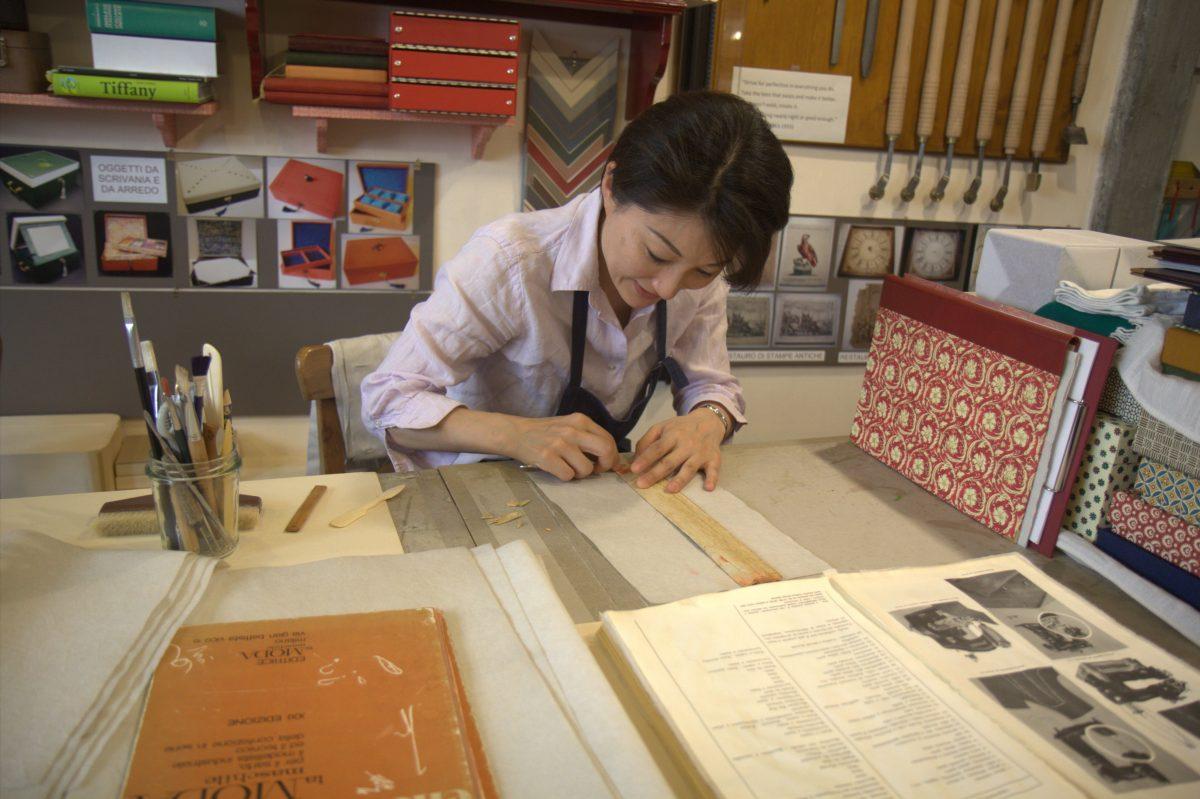 <span style="color: #000000">Kuwata restores a local tailor’s 1950s pattern-making book to protect it for future generations. The bespoke tailor's refers to the book every day. (Lorraine Ferrier/The Epoch Times)</span>