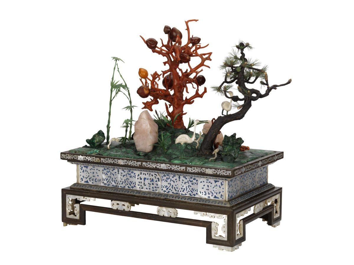 The Chinese miniature garden shows the "Three Friends of Winter": a plum tree in coral, a pine tree in wood and ivory, and a bamboo in tinted ivory. All three endure the cold weather and together symbolize perseverance, integrity, and longevity. (National Maritime Museum, London)