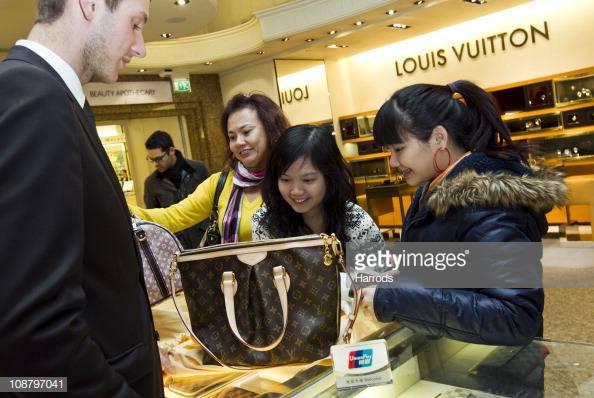 Chinese shoppers make a purchase at the Harrods department store in London on Feb. 3, 2011. (James McCauley/Harrods via Getty Images)
