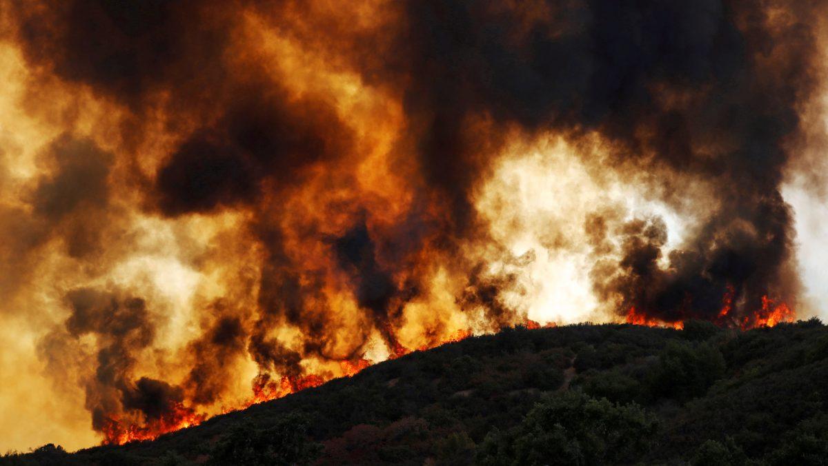 Wind-driven flames roll over a hill toward homes during the River Fire (Mendocino Complex) near Lakeport, Calif., Aug. 2, 2018. (Fred Greaves/Reuters)