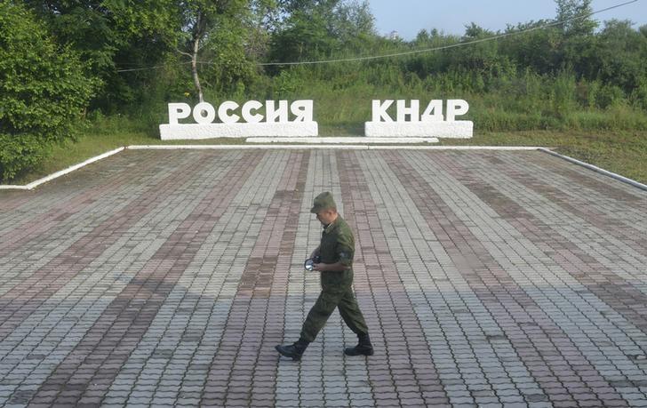 A guard walks along the platform at the border crossing between Russia and North Korea at the North Korean settlement of Tumangan July 18, 2014. The signage reads, "Russia" and "KNDR (Democratic People's Republic of Korea)". (Reuters/Yuri Maltsev/File Photo)