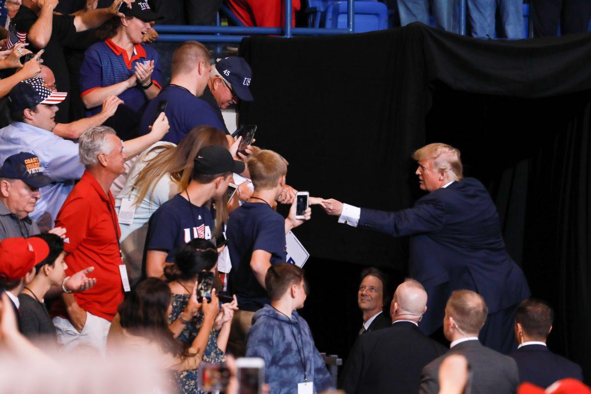 President Donald Trump shakes hands with audience at the end of a Make America Great Again rally in Wilkes-Barre, Penn., on Aug. 2, 2018. (Samira Bouaou/The Epoch Times)