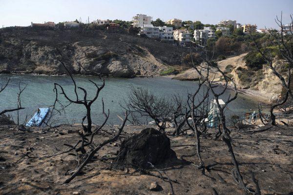 People swim at a beach in Rafina, east of Athens, on Aug. 1, 2018, ten days after the the wildfire. (AP Photo/Thanassis Stavrakis)