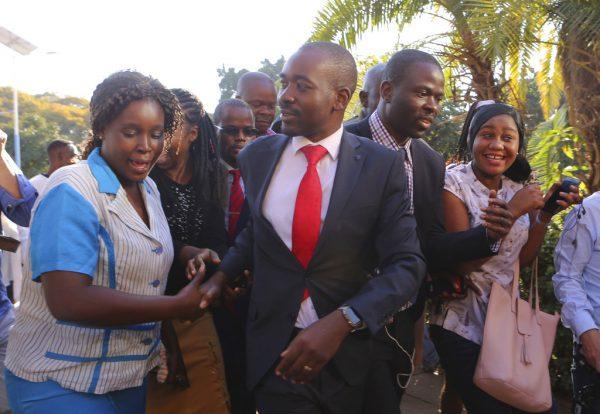 Opposition leader Nelson Chamisa, centre, is greeted by supporters during a visit to see election related violence victims at a hospital in Harare, Zimbabwe, Aug, 2, 2018. (AP Photo/Tsvangirayi Mukwazhi)